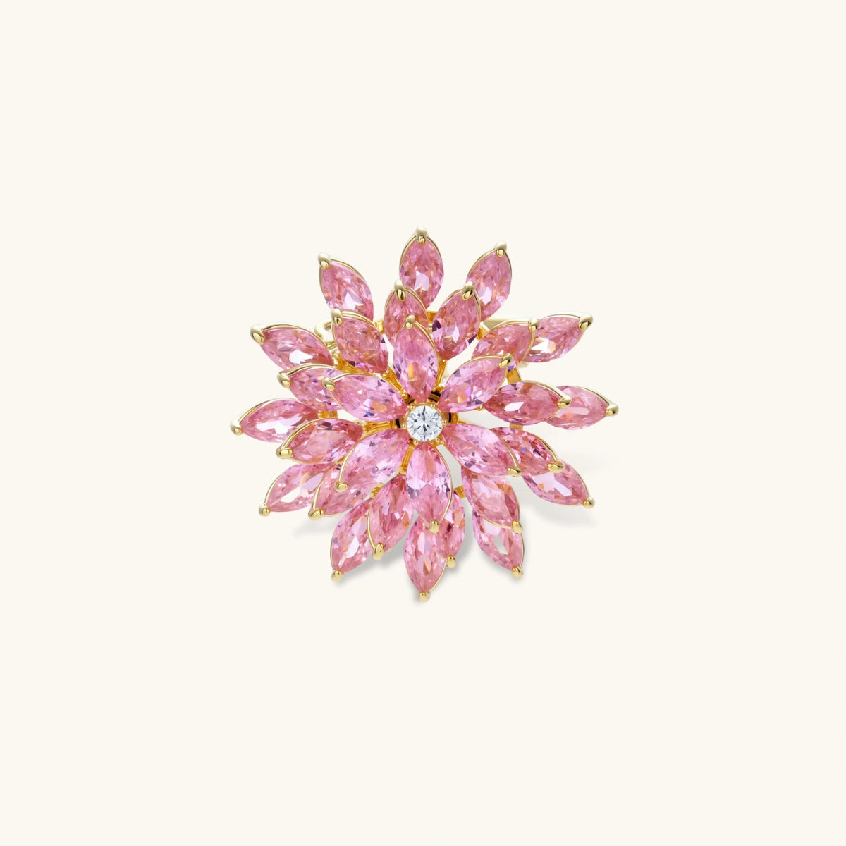 Pink cubic zirconia brooch in floral starburst design with palladium-plated copper setting on white background.