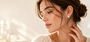 Woman wearing a pearl stud earring in a square silver-tone frame with small stones, VRAEVA